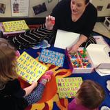LaVista KinderCare Photo #4 - Ms. Morgan working on phonics with some friends!