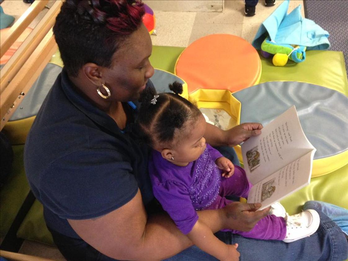 Country Club Hills KinderCare Photo - Ms. Samantha reading to one of the infants.
