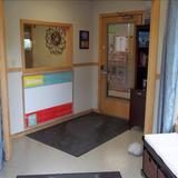 Apple Valley KinderCare Photo #2 - This is the first area that you will encounter when you visit our center. There is an area for families to sit as well as informational books. There is a window that allows the Center Director and Assistant Director the chance to see who is entering the building. The door also has a code that only current families know.