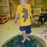 Florence KinderCare Photo #8 - Ryker is painting with his feet!