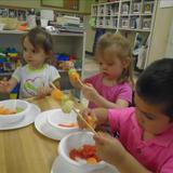 S Arlington Heights KinderCare Photo #4 - Making fruit kabobs helps our Discovery Preschoolers develop hand-eye coordination and fine motor skills.