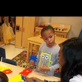 Oak Forest KinderCare Photo #4 - Ms. Tiara engages in building activites with her children.