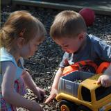 Meadowlands KinderCare Photo #8 - Two toddlers enjoy the Discovery Preschool playground and a little sun.