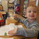 Meadowlands KinderCare Photo #10 - One preschooler shows his excitement while writing about his favorite insect.