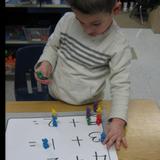 Newington KinderCare Photo #7 - A good portion of our Preschool curriculum focuses on small math concepts. Here our Preschool classroom was identifying numbers while working on one to one correspondence. The children were encouraged to identify each number and utilize our â€œKelsey Countersâ€ to add the numbers up and then count the total number of â€œKelsey Counters.â€