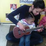 Newington KinderCare Photo #5 - Here you can see our Discovery Preschool teacher teaching our children all about the Banjo! Miss Marilex enjoys playing the Banjo in her spare time and takes pride in incorporating this multicultural musical instrument into the childrenâ€™s classroom curriculum!