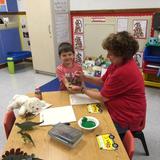 South Shore KinderCare Photo #4 - Making dinosaur prints at our Community Event.