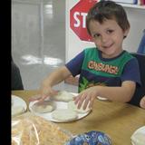 South Shore KinderCare Photo #6 - Making cheese biscuits in cooking class!