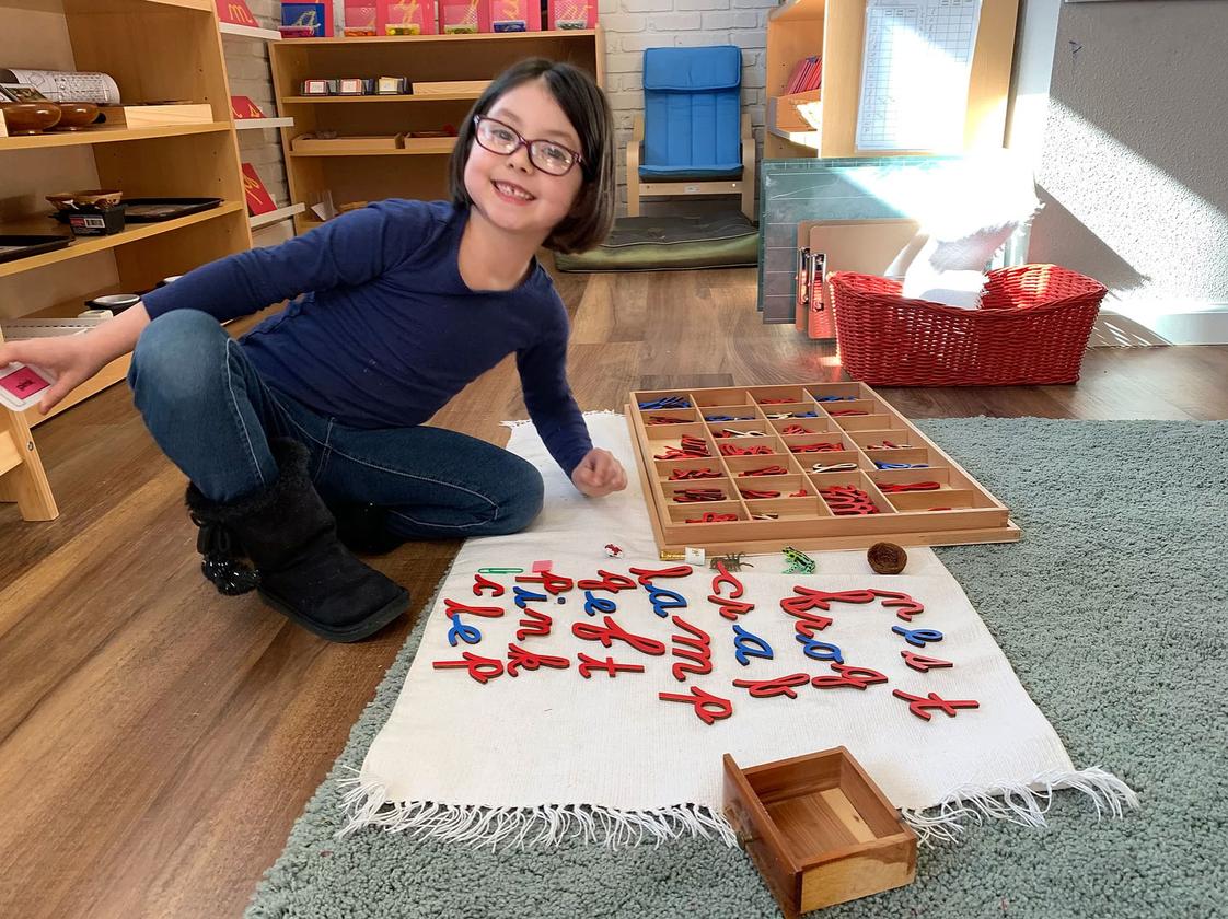 OKC Heartland Montessori School Photo - Working with the movable alphabet.