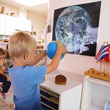 Childrens Garden Montessori Photo - Boy with globe