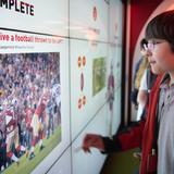 Stanbridge Academy Photo #9 - An upper elementary student learns about physics using a wall-sized touch screen while on an experiential learning trip to Levi's Stadium.