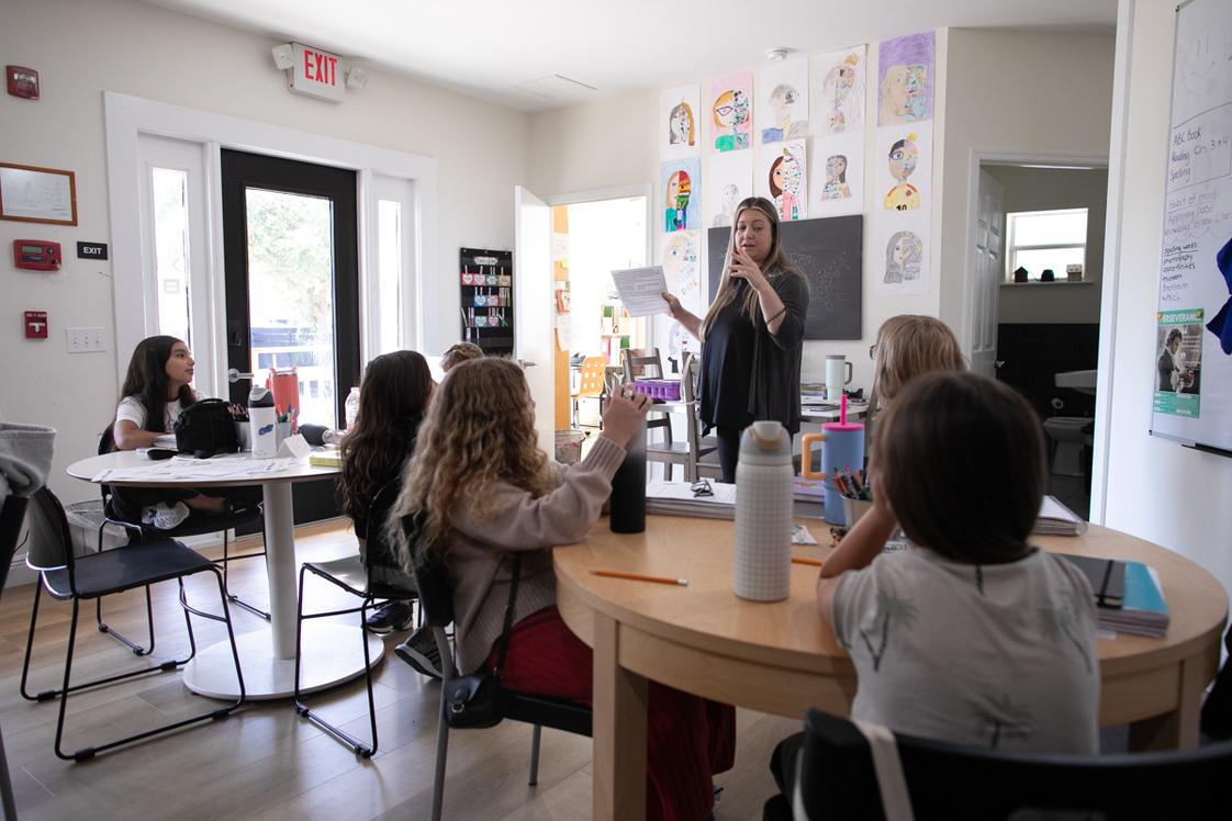 Walden Community School Photo #1 - Students engage in a lively class discussion, sharing ideas and reflecting together in a bright, welcoming space that celebrates curiosity and collaboration.