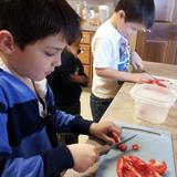 Risen Lord Montessori School Photo #8 - Food prep/Cooking is a hallmark of our school. Children learn to prepare their own snacks and learn the value of community when they cook together. Special opportunities to cook include our Thanksgiving Celebration and the Elementary Botany curriculum.
