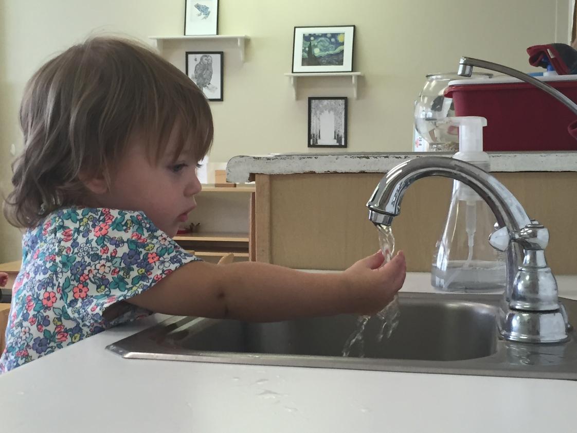 Our World Montessori Photo #1 - Focusing on washing hands - 15 months old