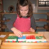 Monarch Montessori School Photo #7 - Practicing 4-digit addition with the Stamp Game