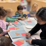 Academy On The Hills Photo #3 - Toddlers classroom working on a shape and color activity. Our Thematic Curriculum provides students with a wide variety of activities that continue to engage our students while combining language arts, literacy, math, science, creative arts and more as an age appropriate level.
