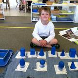 Montessori School at Lone Tree Photo #7 - Geometric Solids, a traditional Montessori activity, where children learn about geometry and to identify some solid figures.