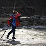 Sparhawk Academy Photo #2 - A Sparhawk boy ventures forth onto a frozen brook on campus. Direct engagement with creation is a cornerstone of our curriculum.