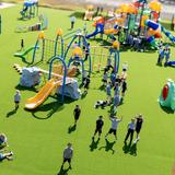 LIH- Lycée International de Houston Photo #5 - Young students enjoy a dedicated outdoor playground designed for safe, active play and exploration, fostering both fun and learning in an open-air environment