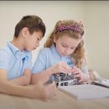 Molo Bilingual Montessori School Photo - Students work with hands on materials collaboratively to build teamwork, problem solving and leadership skills.