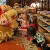 Our House Montessori Photo #2 - Our House Montessori children observing a Lion Dance as part of a lesson on Lunar New Year celebrations