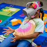 Corbett Preparatory School of IDS Photo #4 - A kindergartener experiences VR as part of an IB unit studying space.