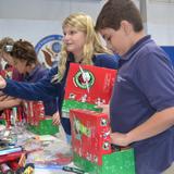 Naples Christian Academy Photo #4 - Students, parents, faculty and staff packed 154 shoeboxes for Operation Christmas Child! After packing, everyone enjoyed cake to celebrate Jesus and His coming.