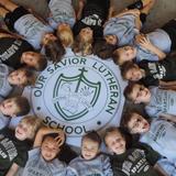 Our Savior Lutheran School Photo - Our Savior's Kindergartners around the crest that represents the strengths from which our school is founded.