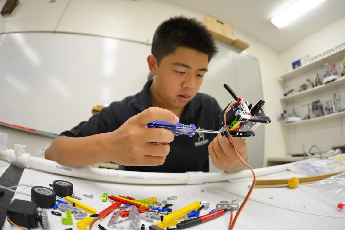 Hanalani Schools Photo #1 - Hanalani has a highly successful robotics program that contributed to two International Championship and 4 Regional Championship Botball teams. Here a student builds a robot from the multitude of parts and tools at his disposal.