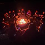 St. Frances of Rome Photo #3 - 8th Grade students around a campfire at Camp Tecumseh