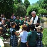 Christ The King Catholic School Photo - Our priest, Father Todd Riebe, blessing our new Sts. Isidore & Maria Garden.
